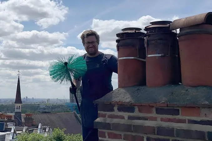 Chimney service professional working at a residential fireplace