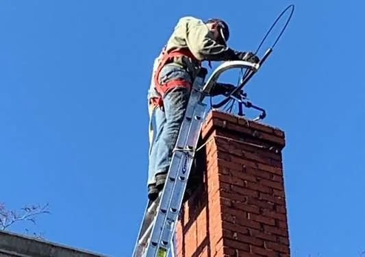 Residential chimney being visually inspected