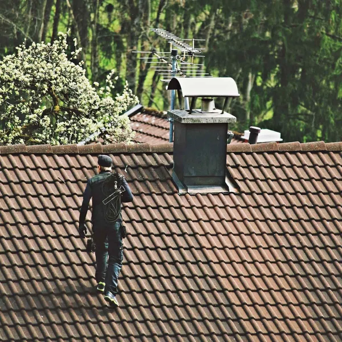 Chimney sweep cleaning the flue of a residential chimney
